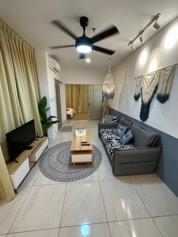 a living room with a couch and a table at Blest Loft 7 Manhattan Suites ITCC in Penampang