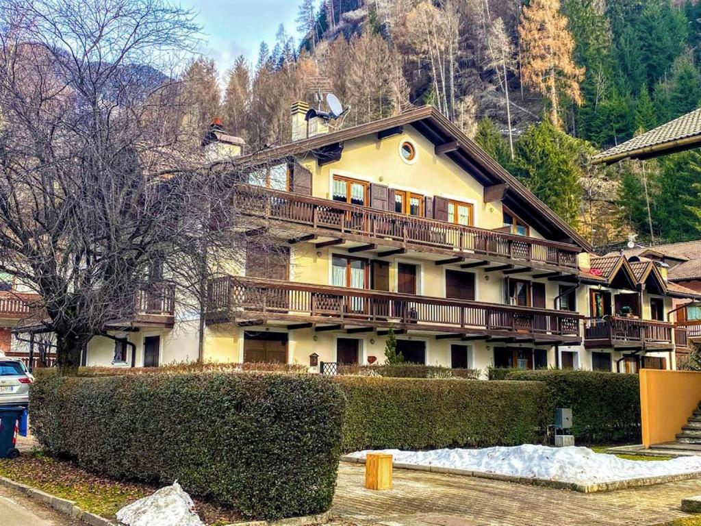 a large house with balconies on the side of it at Lago 49 in Predazzo