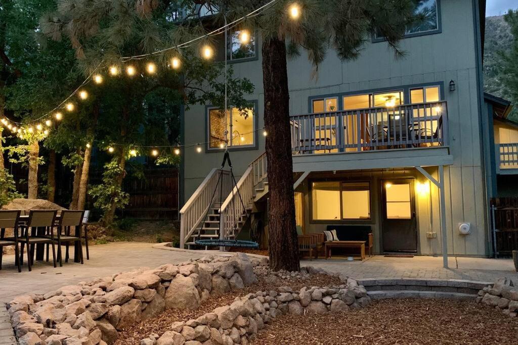 a house with a tree and a balcony with lights at Elden House - Perfect Mountain Escape for Groups & Families! in Flagstaff