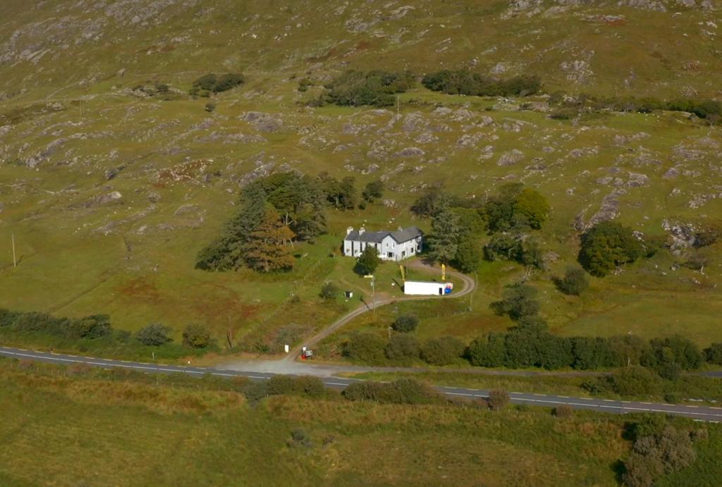 an aerial view of a house on a hill at Ben Lettery Hostel in Ballynahinch