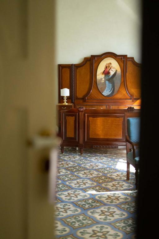 a room with a bed with a picture of a woman at Palazzo Zacà in Gallipoli