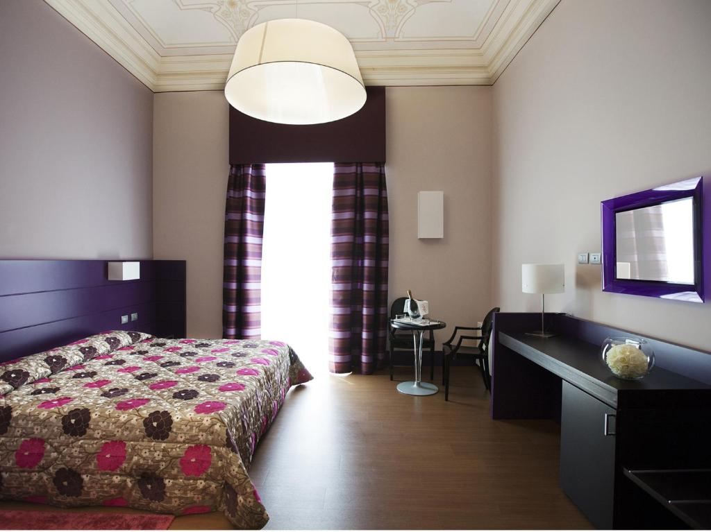 Postel nebo postele na pokoji v ubytování Hotel Vittoria