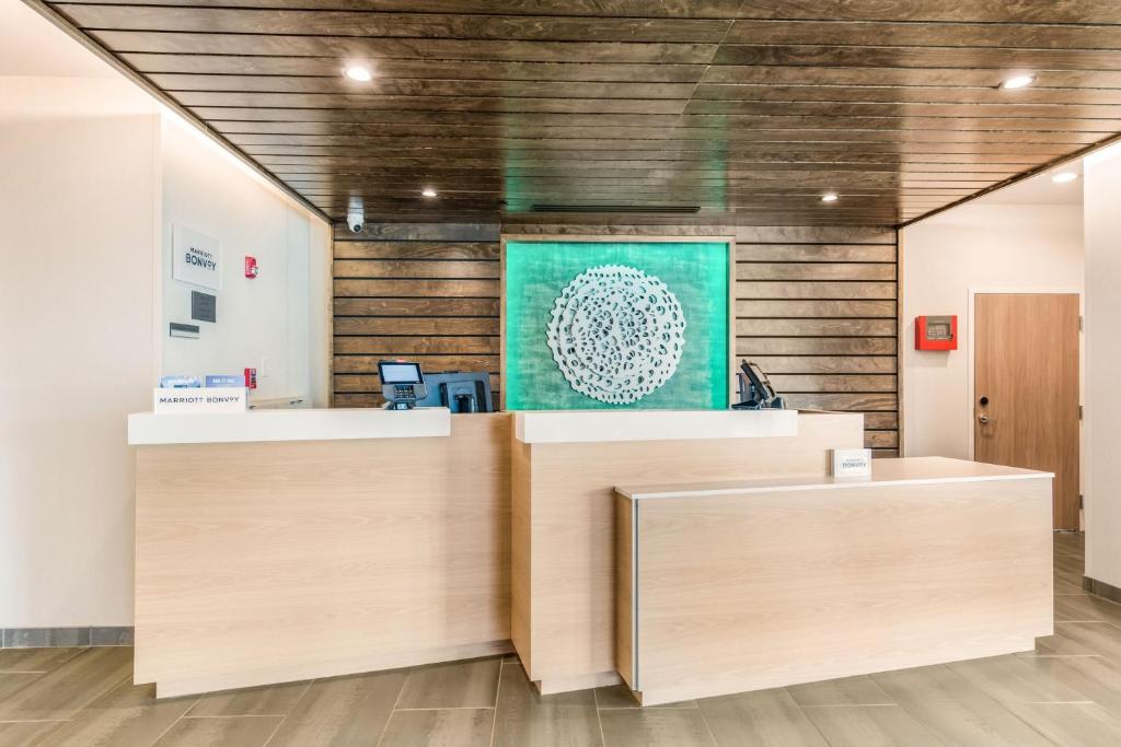 an office with wooden walls and a green painting on the wall at Fairfield by Marriott Inn & Suites Knoxville Clinton in Clinton