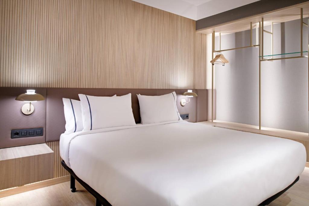 a large white bed in a hotel room at AC Hotel by Marriott Tenerife in Santa Cruz de Tenerife