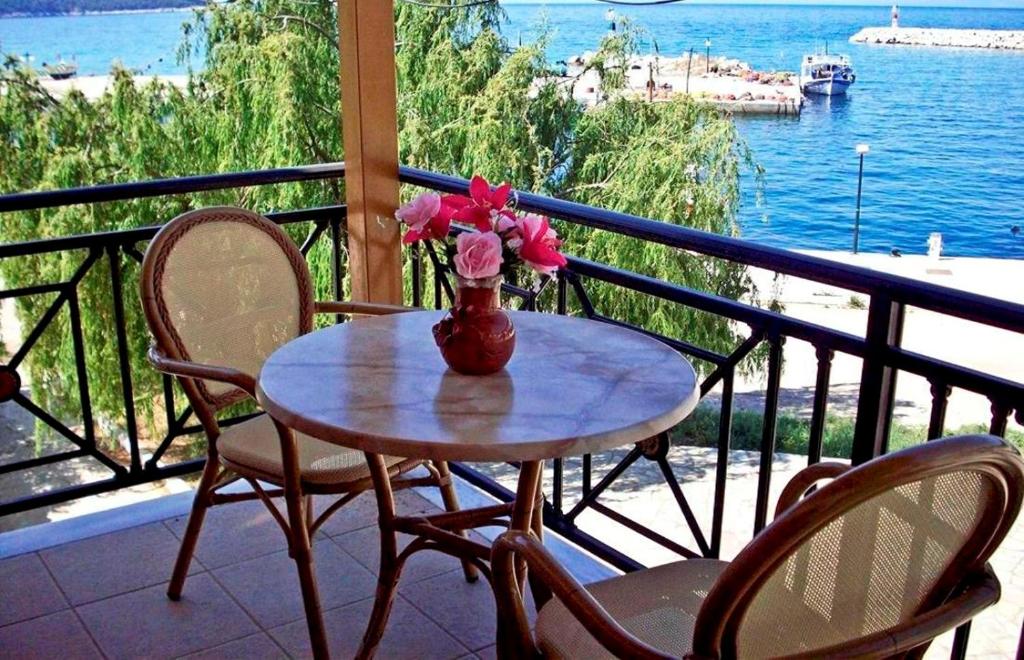 a vase of flowers sitting on a table on a balcony at Anna Maria - Vanessa Apartments in Neo Klima