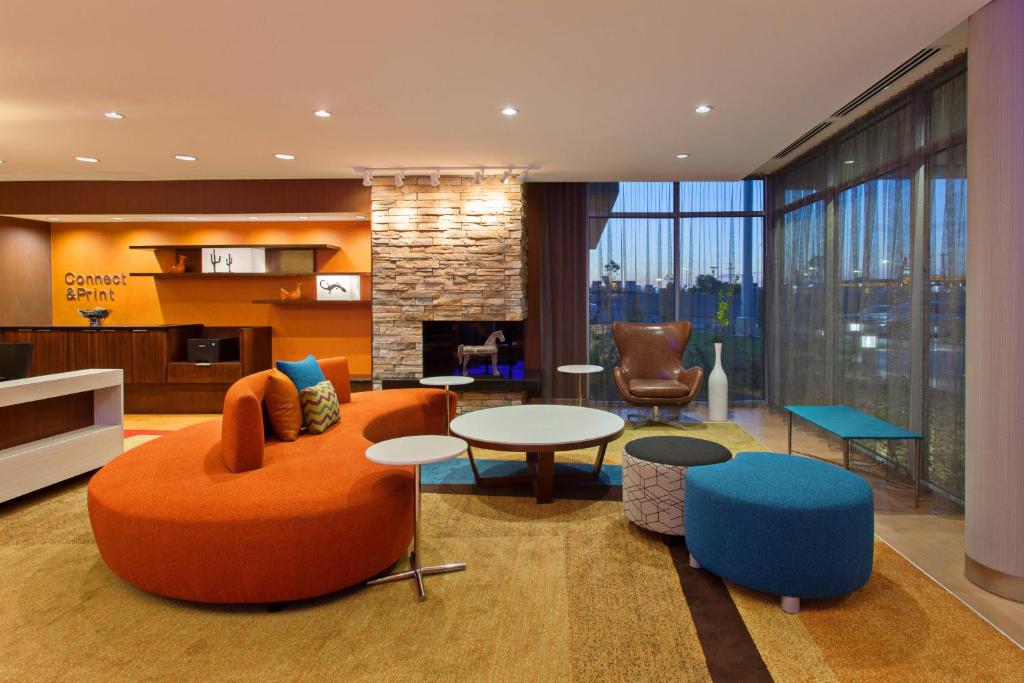 a living room with a couch and a table and chairs at Fairfield Inn & Suites by Marriott Tucumcari in Tucumcari