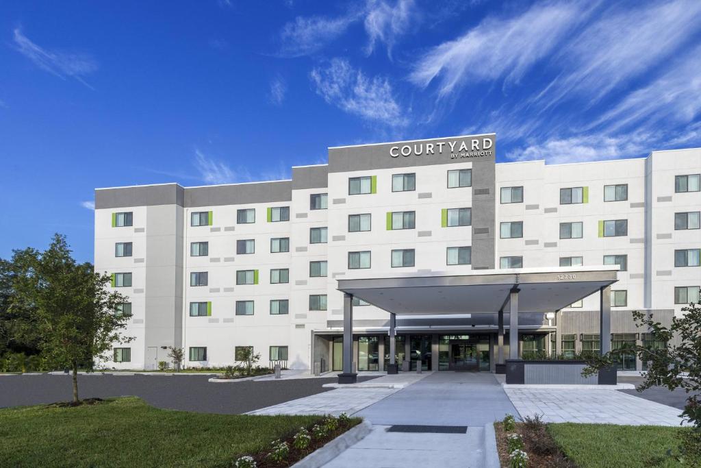 a large white building with a court yard at Courtyard by Marriott Tampa Northwest/Veterans Expressway in Tampa