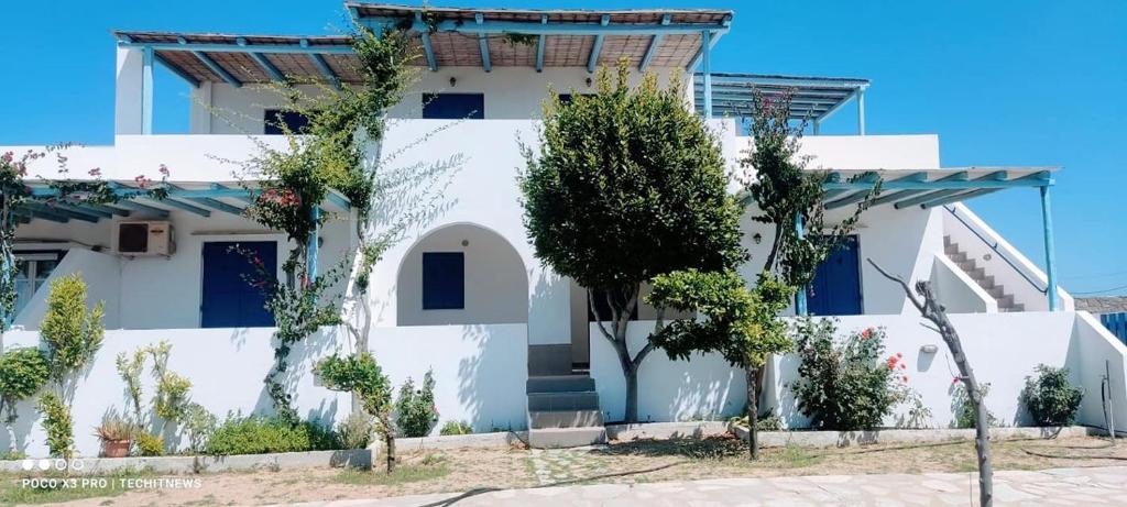 a white house with trees in front of it at CIELO Summer House Paros in Santa Marina