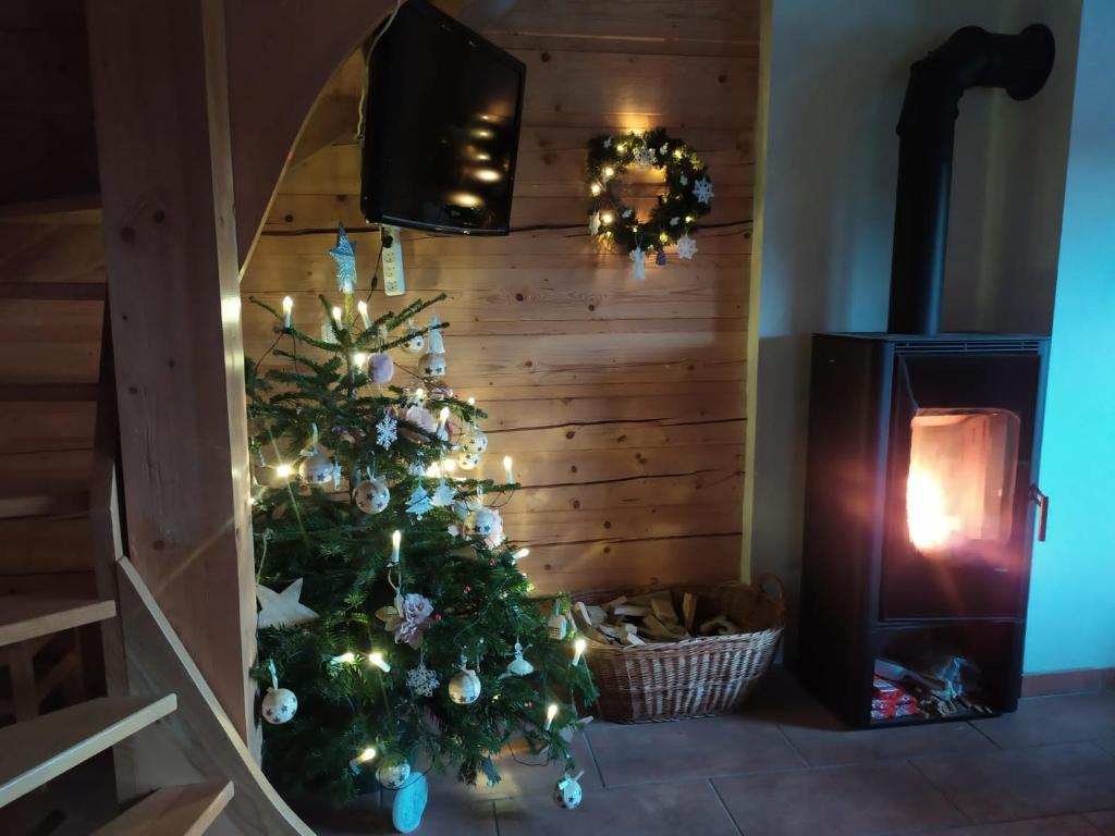 a christmas tree in front of a fireplace at Drevenica Západné Tatry in Žiar