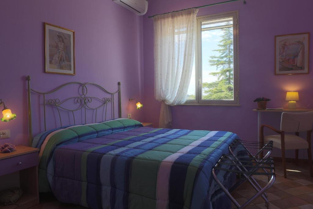 Postel nebo postele na pokoji v ubytování Villa dei giardini