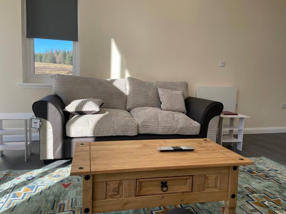 a living room with a couch and a coffee table at Remote Wilderness - sleeps 4 to 6 in Halkirk