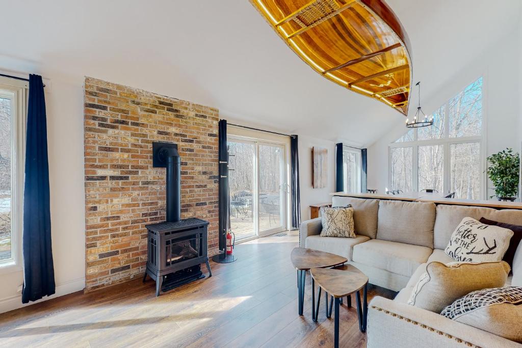 a living room with a couch and a brick wall at The Cottages at Blue-Cottage 1 in Blue Mountains