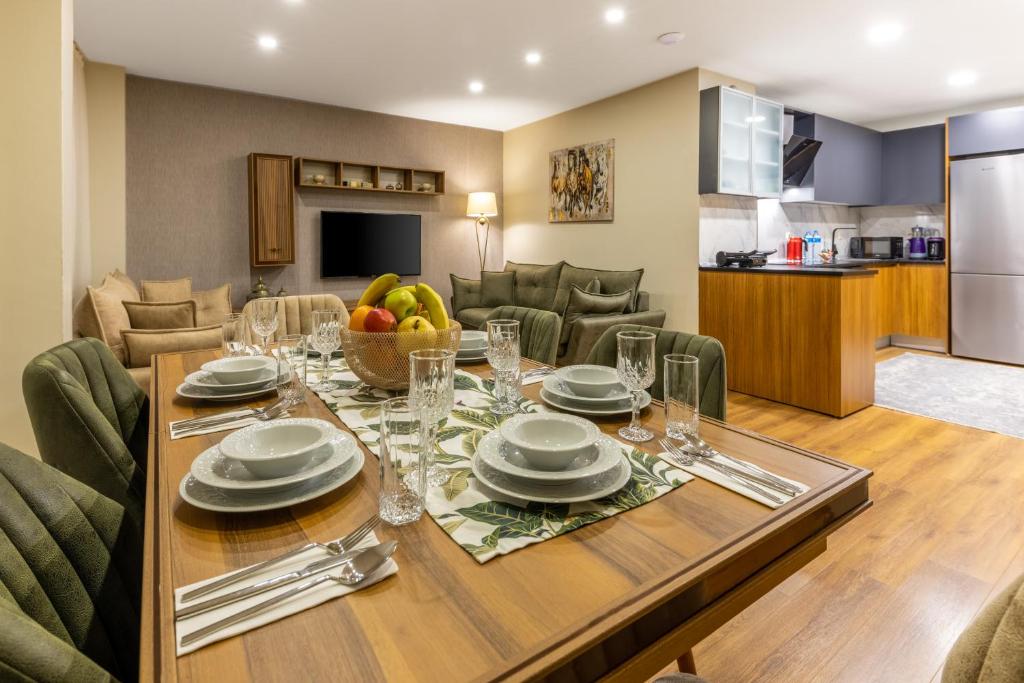 a dining room and kitchen with a table and chairs at BayMari Suites Plus Florya in Istanbul