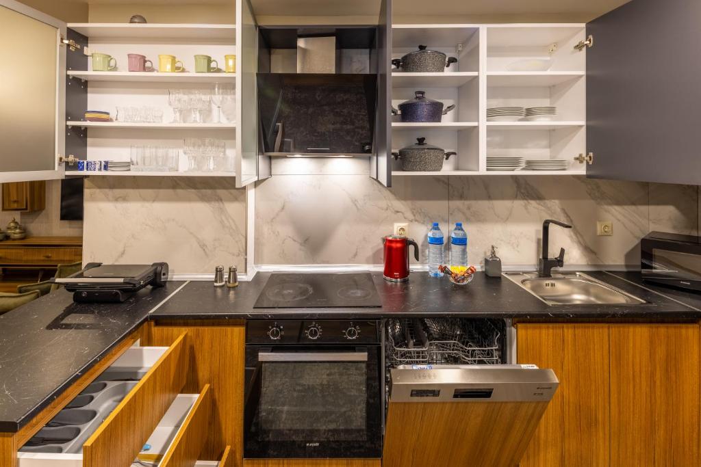 a kitchen with a sink and a stove at BayMari Suites Plus Florya in Istanbul
