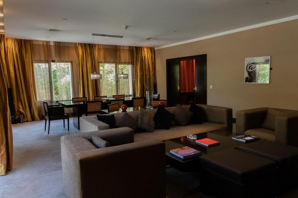 a living room with a couch and a table at Hotel Casino Magic in Neuquén