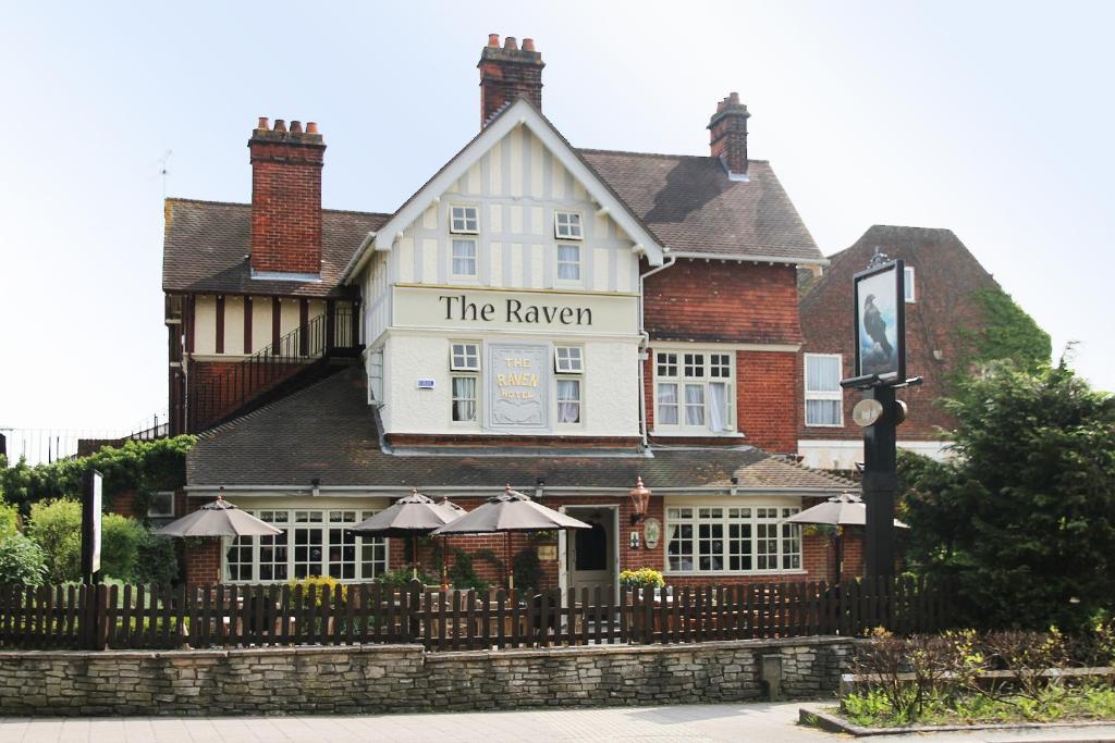 a building with a sign that reads the tavern at Raven Hotel by Greene King Inns in Hook