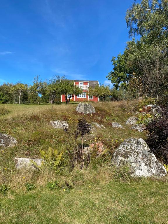 uma casa numa colina com pedras num campo em Naturnära hus utanför Reftele närhet till Isaberg och High Chaparral em Reftele