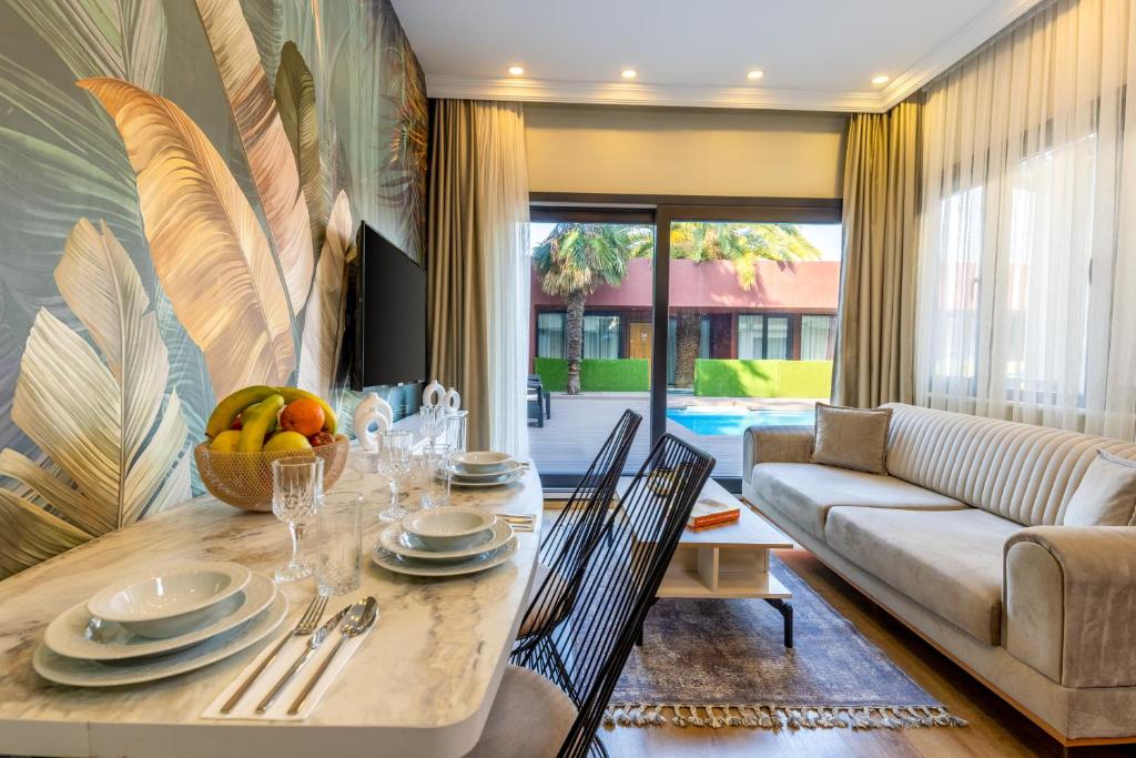 a living room with a table and a couch at BayMari Suites Plus Florya in Istanbul
