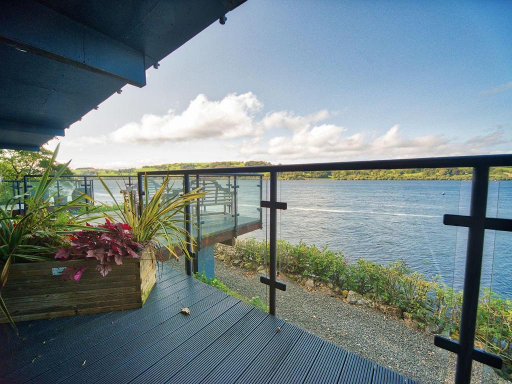 a deck with a view of the water at Tegid Lakeside - Bala Lake in Bala