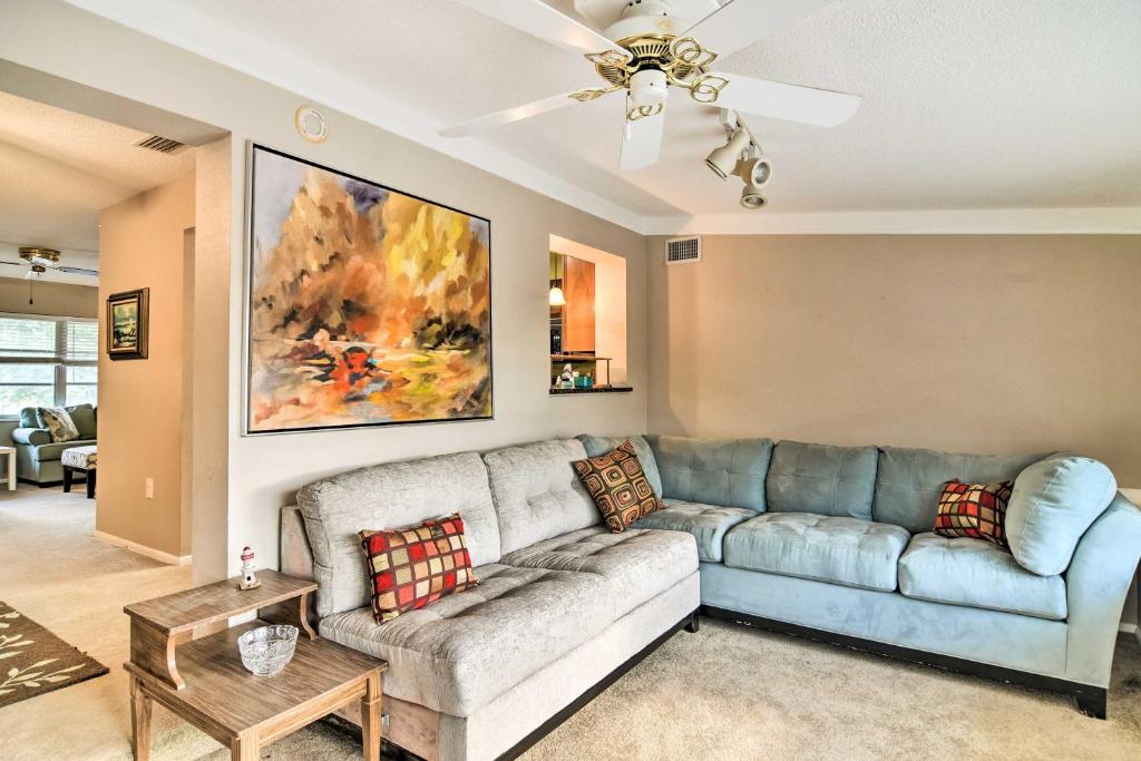 a living room with a couch and a ceiling fan at Bradenton Snowbird Sanctuary with Covered Patio and Grill in Bradenton