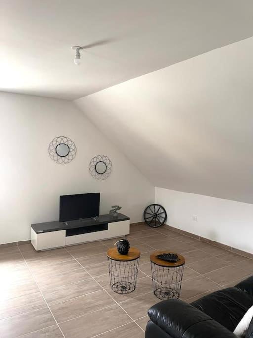 ein Wohnzimmer mit einem Sofa und einem Flachbild-TV in der Unterkunft appartement - châtenois in Châtenois
