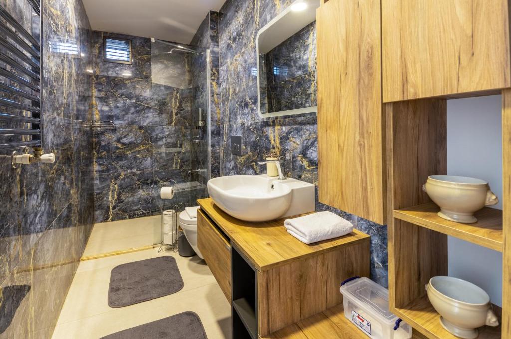 a bathroom with a sink and a toilet at BayMari Suites Plus Florya in Istanbul