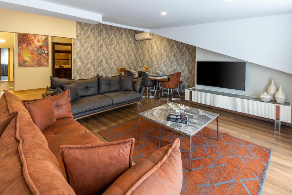 a living room with a couch and a table at BayMari Suites Plus Florya in Istanbul