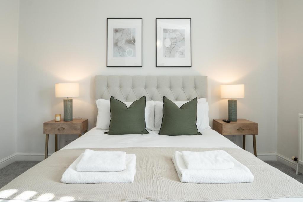 a bedroom with a large white bed with two lamps at Southview Stays - Three bedroom House in Chester