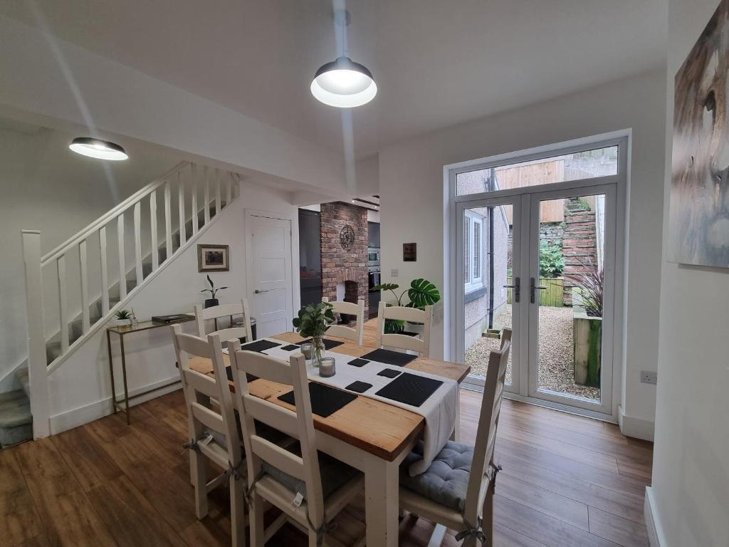 a kitchen and dining room with a table and chairs at Hill View in Abertillery