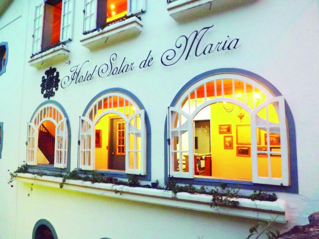 a building with three windows on the side of it at Hotel Solar de Maria in Ouro Preto