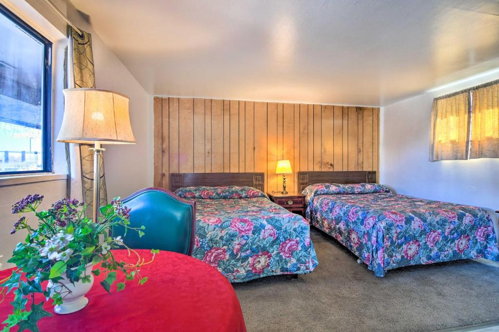 a hotel room with two beds and a red table at Pet-Friendly Vacation Rental Near Boyd Lake in Loveland