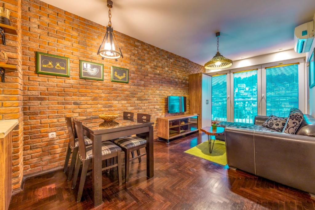 a living room with a brick wall at Ohrid Boutique Apartments in Ohrid