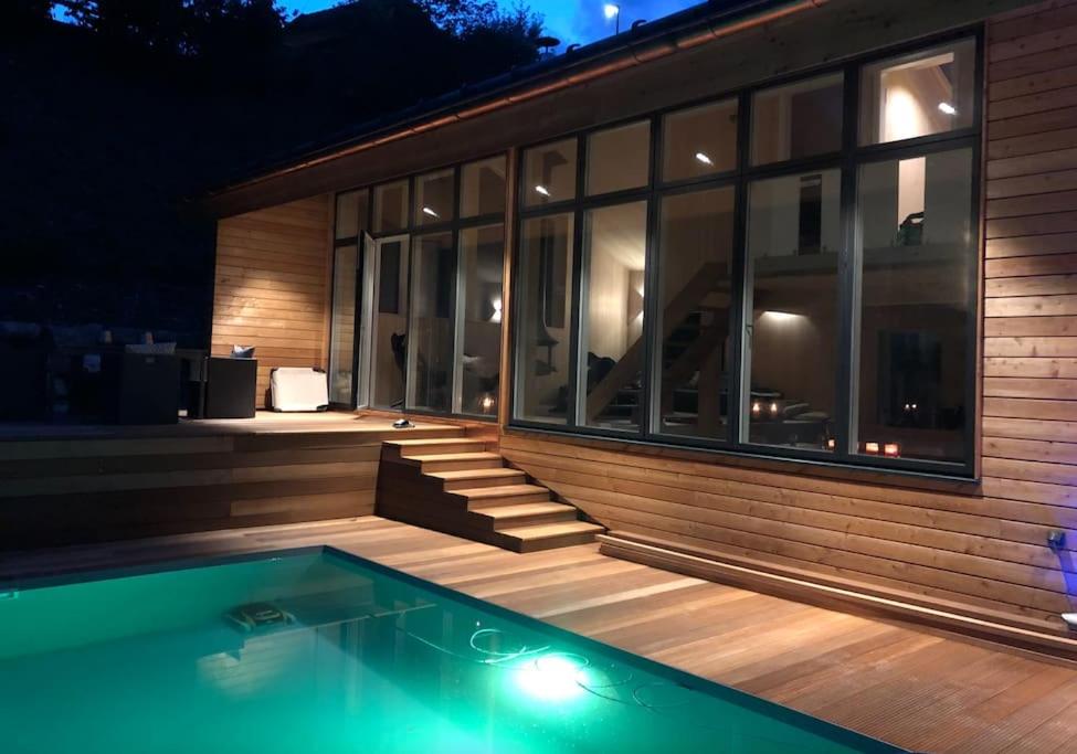 a house with a swimming pool at night at NEU: Alpen-Chalet Seekarblick mit Pool in Lenggries