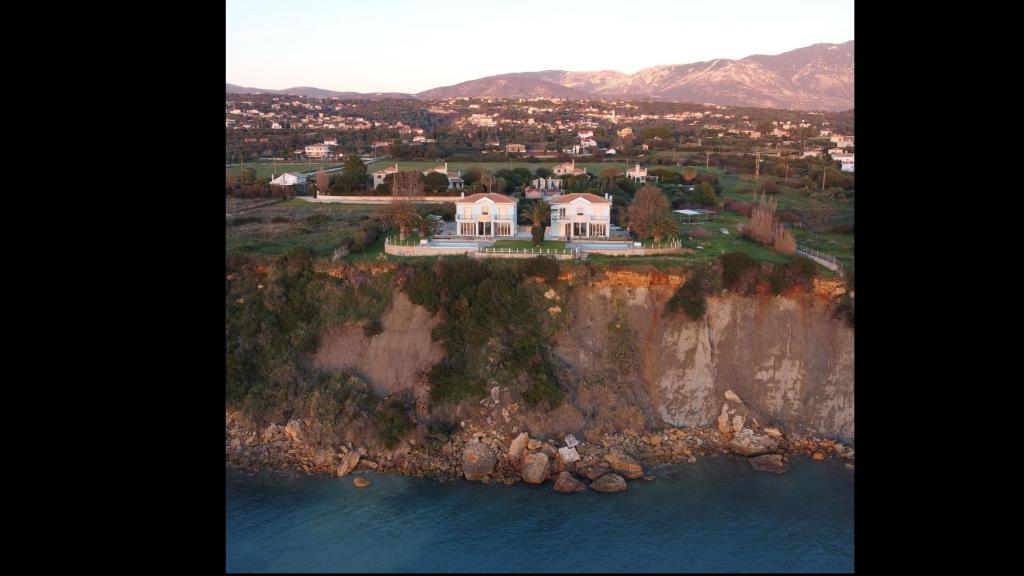 an aerial view of a house on a cliff at Ionian Blue Luxury Villas in Svoronata