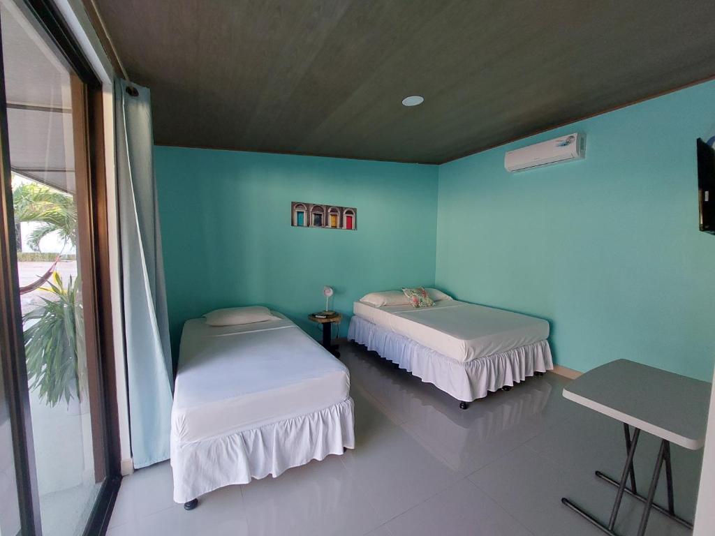 Postel nebo postele na pokoji v ubytování Hotel Carlota Tamarindo