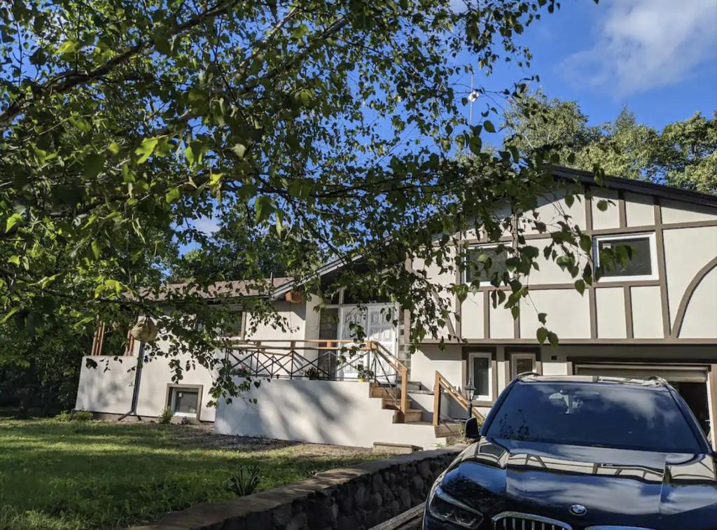 een auto geparkeerd voor een huis bij Vacation home/Cottage on Private 20 Acres Land - Resort-a/Spa Cottage in Cookstown