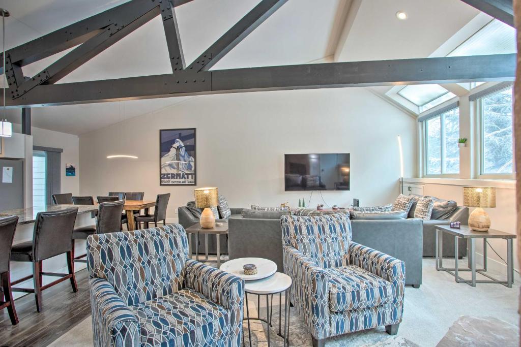 a living room with blue and white chairs and tables at Modern Townhome about 4 Miles to Beaver Creek Resort! in Avon