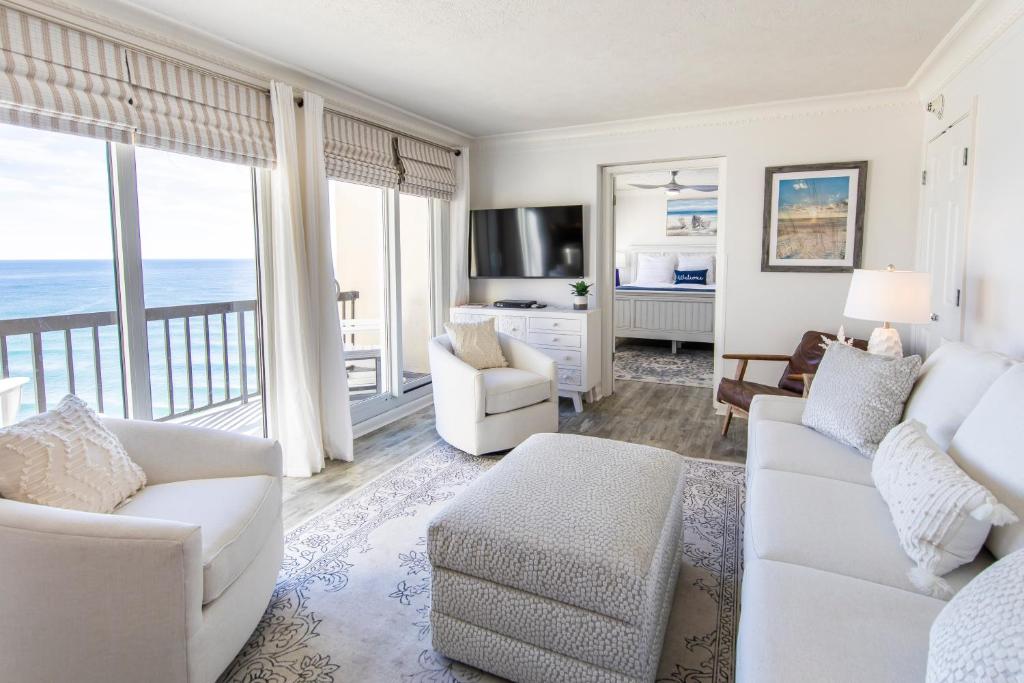 a living room with white furniture and a view of the ocean at Pinnacle Port PH22 in Panama City