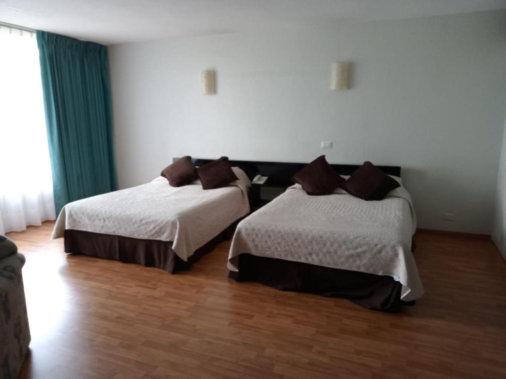 Postel nebo postele na pokoji v ubytování Gran Hotel Xalapa