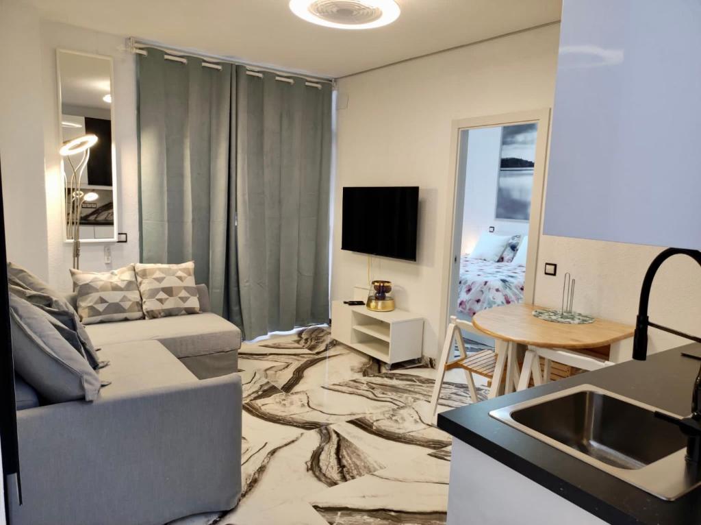- un salon avec un canapé et une table dans l'établissement 2 Bedrooms Flat + Balcony + Parking at Las Canteras Beach, à Las Palmas de Gran Canaria