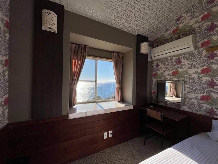 En eller flere senge i et værelse på UMI SORA VILLA 伊豆河津