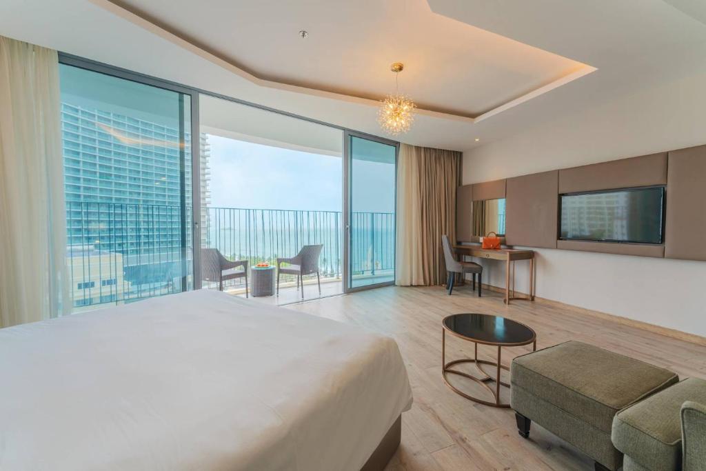 a bedroom with a large bed and a room with a view at Moonlight Bay Panorama Ocean View in Nha Trang