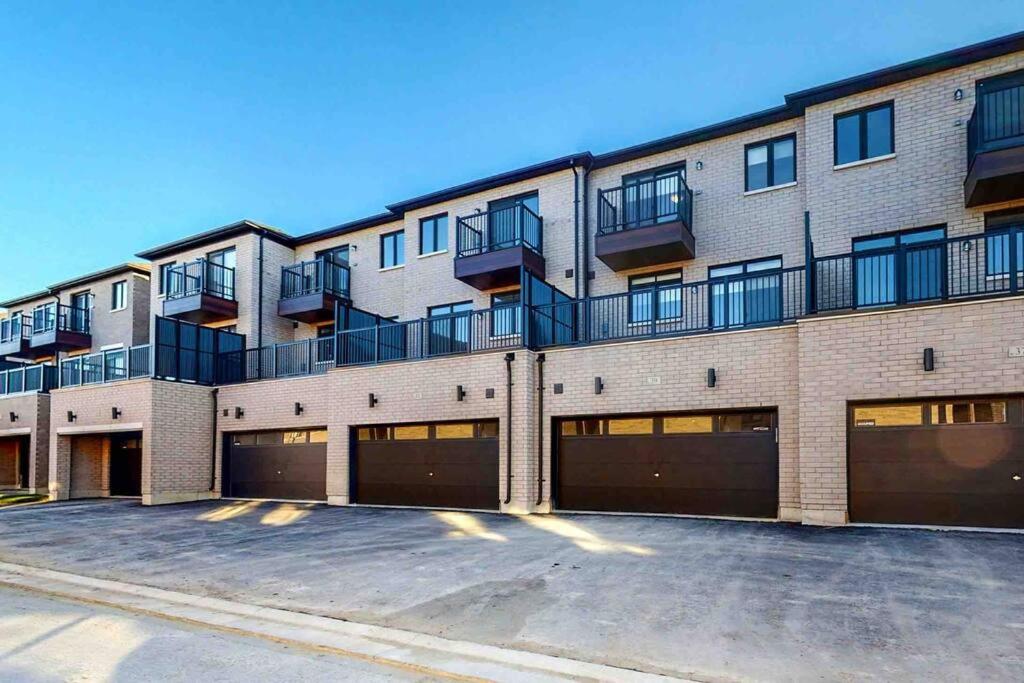 an apartment building with a parking lot in front of it at New Luxurious Studio Apartment in Brampton