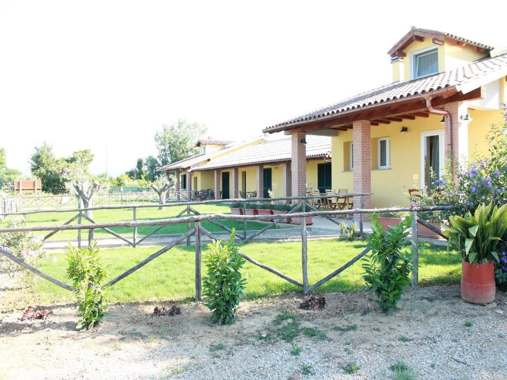 a fence in front of a house at Agriturismo dal Pastore in Follonica