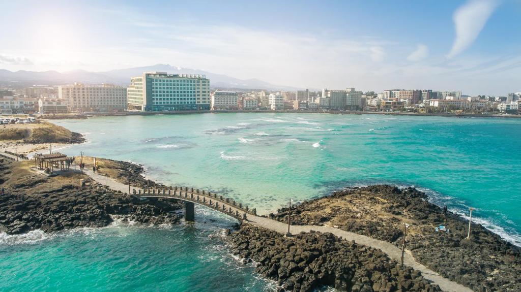 an aerial view of the ocean and a city at Utop Ubless Hotel Jeju in Jeju