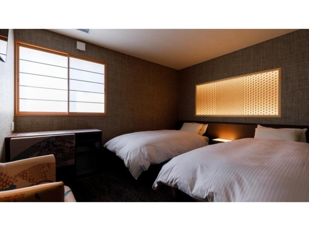 Postelja oz. postelje v sobi nastanitve Hotel Rashiku Kanazawa - Vacation STAY 49656v