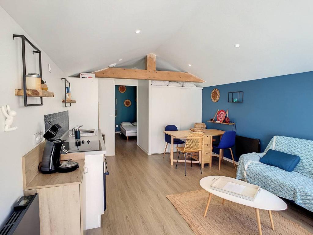 a kitchen and living room with a couch and a table at Maison Aytré, 2 pièces, 4 personnes - FR-1-710-12 in Aytré