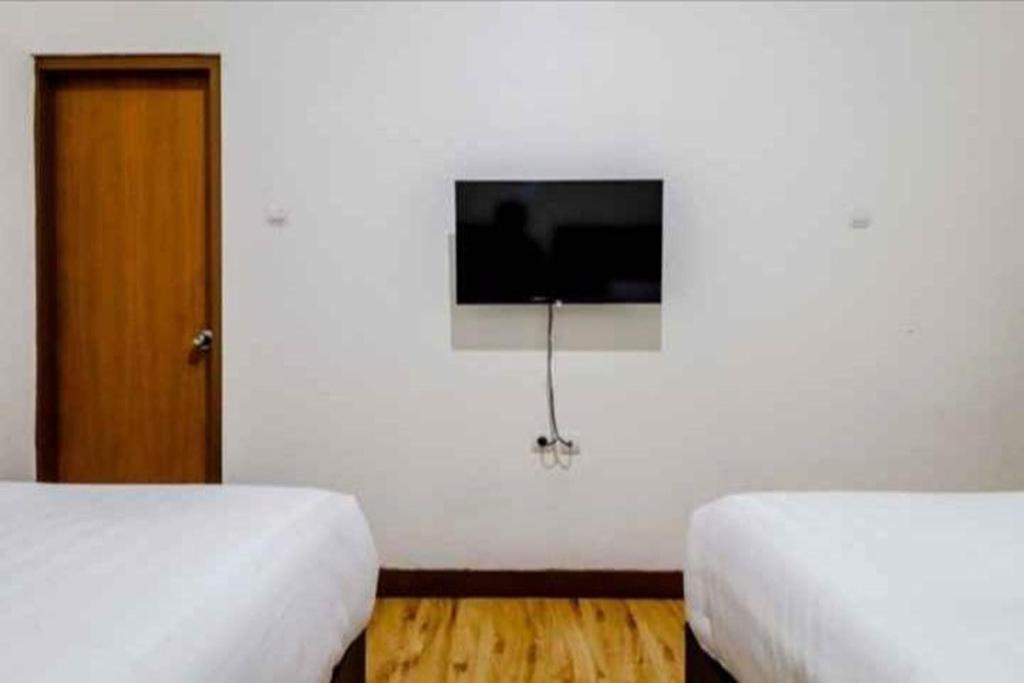 Postel nebo postele na pokoji v ubytování Hotel Sumaryo