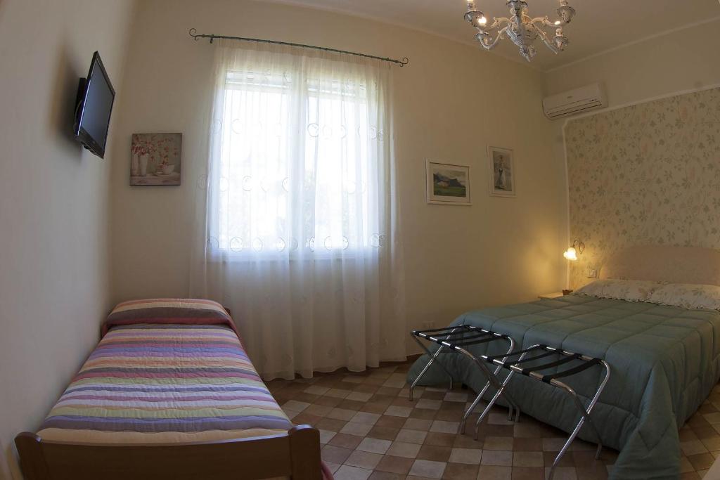 Postel nebo postele na pokoji v ubytování Villa dei giardini
