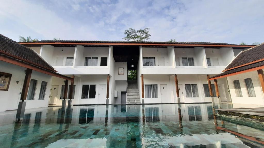 a courtyard of a building with a swimming pool at Sinom Borobudur Heritage Hotel in Borobudur